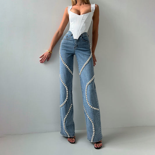 Jeans with a denim design featuring rhinestones around